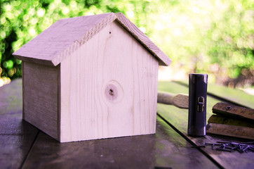 Small wooden house with hammer nails and ruler