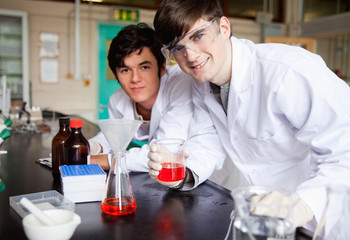 Students showing a red liquid