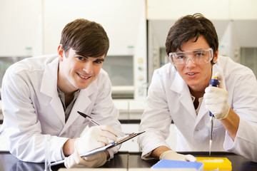 Handsome scientists making an experiment