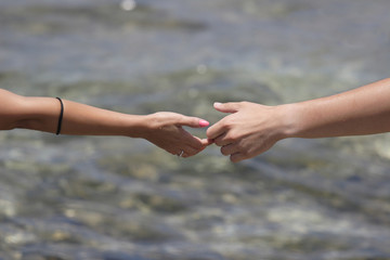 Young man and woman walking on the shore