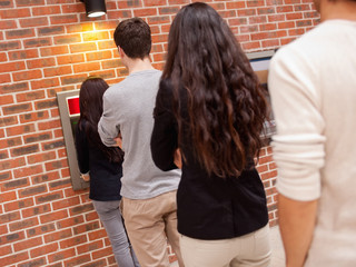 People queuing to withdraw cash