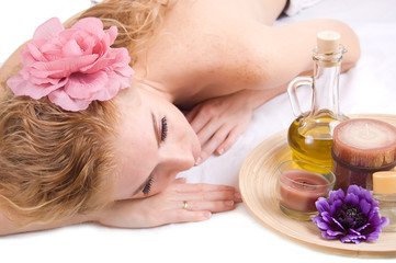 Obraz na płótnie Canvas Woman lying with spa products
