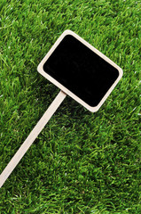 blank blackboard label on the grass
