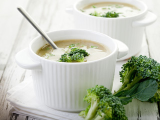 broccoli soup on bowl over wood background