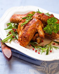 Roasted chicken wings with rosemary sprigs