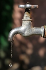 Vintage outdoor tap with falling droplets