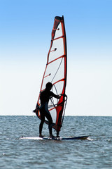 Silhouette of a man windsurfer