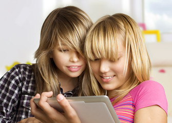 Teenage girls using touchpad