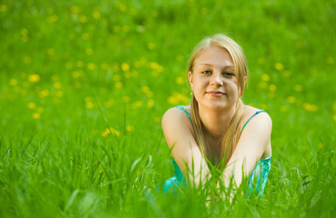 Naklejka na ściany i meble girl relaxing outdoor in grass