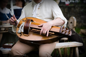 man is playing a historical musical instrument