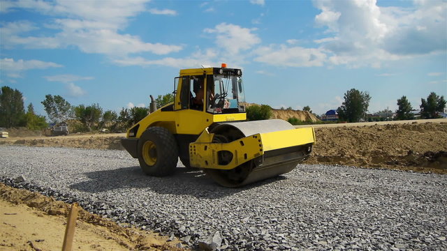 a road construction by a yellow road roller