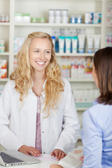 lächelnde kundin kauft in der apotheke