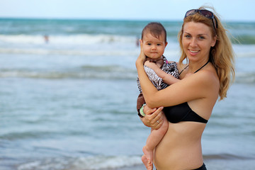 Baby and mother on the beach