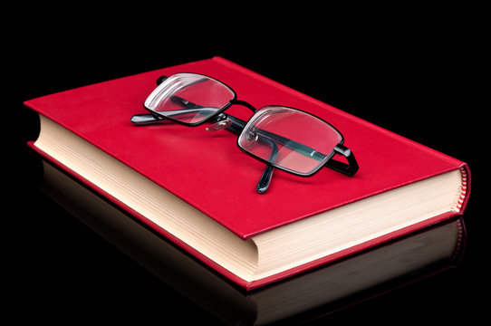 glasses and red book