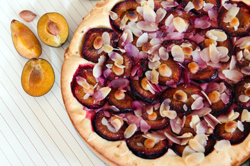 Plum pie and on a wooden white background