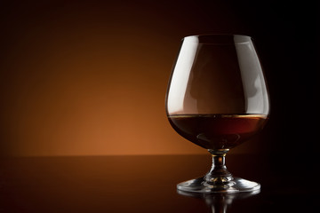 Glass of cognac at the bar counter with copy space