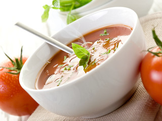 tomato soup with basil leaf on bowl