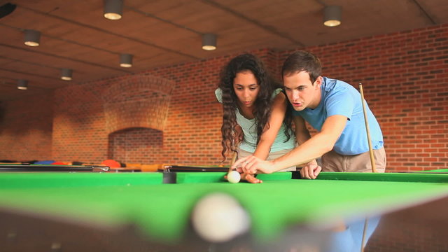 Handsome man teaching pool