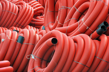 Stock red coiled plastic pipes