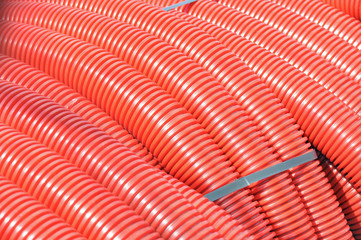 Detailed view of a stock red coiled plastic pipes