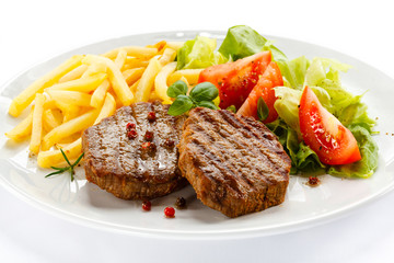 Grilled steak, French fries and vegetables