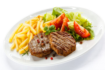 Grilled steak, French fries and vegetables