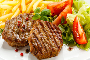 Grilled steak, French fries and vegetables
