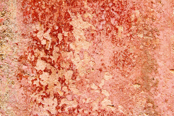 Aged weathered painted wall in red grunge tones