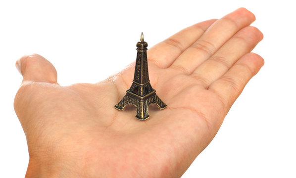 Hand showing a tiny Eiffel Tower