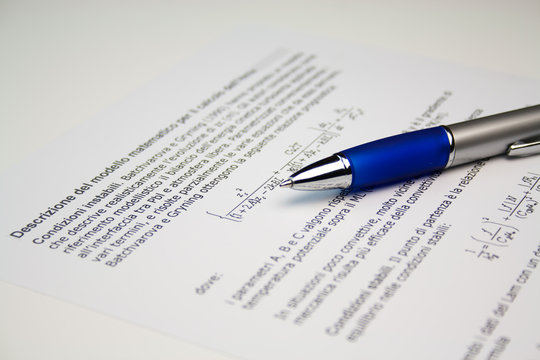 pen lying on a scientific paper image