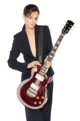Young female in suit holding red electric guitar