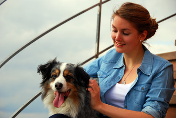 Girl and dog sitting on a stairway