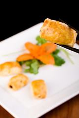 Chinese pastry held by chopsticks