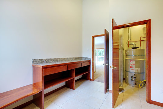 Utility Laundry Room With Desk And Water Heater