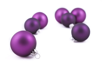Purple christmas decorations on white background
