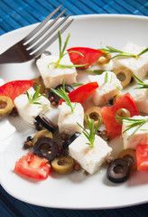 Cheese appetizer with olives and rosemary