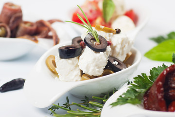 Cheese appetizer with olives and rosemary