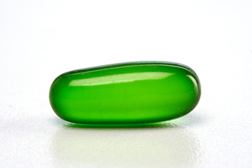 Green gel pill on white