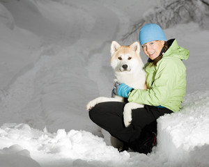 Winter portrait, woman with akita dog