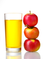 Delicious apple juice in glass and apples isolated on white