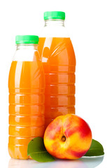 Peach juice in bottles and nectarine isolated on white