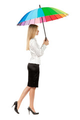 Full length, side view of young business woman under umbrella