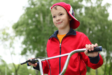 Boy on a bicycle in the green park