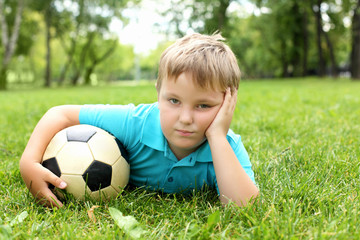 Little boy in the park with a ball