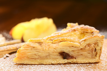 A slice of delicious apple pie with sugar powder