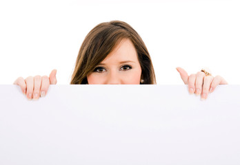 Picture of beautiful brunet woman holding a blank billboard