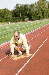 Fototapeta premium middle age senior man exercising running on sports field and run