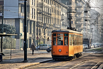 Old vintage orange tram on the street of Milan, Italy