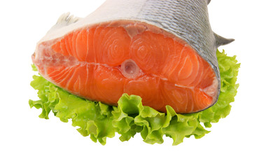 Salmon steak with greens isolated on white