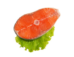 Salmon steak with greens isolated on white